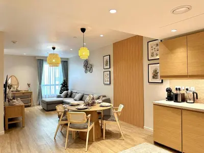 a kitchen and living room with a table and a couch at Family apartment next to the beach in Dubai