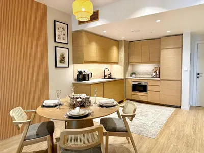 a kitchen and dining room with a table and chairs at Family apartment next to the beach in Dubai