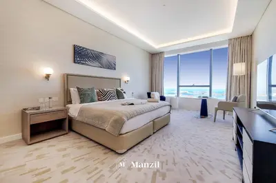 a hotel room with a bed and a television at Manzil - Studio Apartment with Aura Pool & Sea View at The Palm Tower in Palm Jumeirah in Dubai