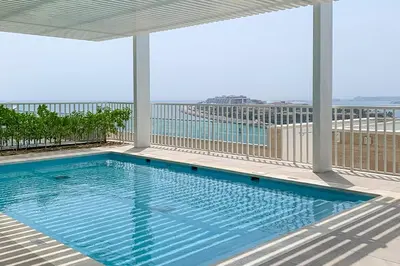 a swimming pool on the balcony of a building at Frank Porter - Beach Vista Tower 2 in Dubai