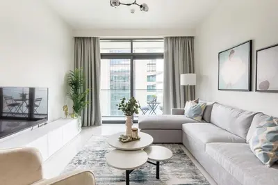 a white living room with a couch and a table at Frank Porter - Beach Vista Tower 2 in Dubai