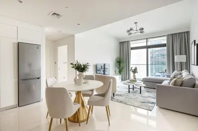 a white living room with a table and chairs at Frank Porter - Beach Vista Tower 2 in Dubai