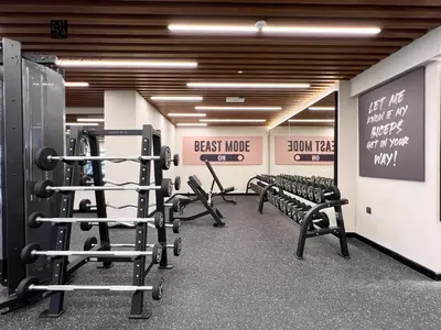 a row of benches in a gym with signs on the walls at Mira Holiday Homes - Serviced apartment in Downtown in Dubai
