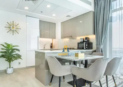 a kitchen with a dining table and chairs at 2 Bed in Azzizi Farhad with Burj Khalifa view by Desert City Stays in Dubai