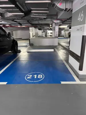 a parking garage with a car parked on a blue floor at Cosmos Living 1 Bedroom Paramount Hotels in Dubai