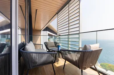 a balcony with a table and chairs and the ocean at Welcome Home - Bluewaters brand new 2-bedroom in Dubai