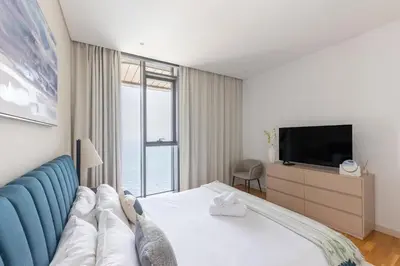 a hotel room with a bed and a tv at Welcome Home - Bluewaters brand new 2-bedroom in Dubai