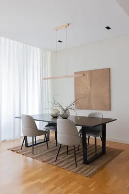 a dining room with a black table and chairs at Welcome Home - Bluewaters brand new 2-bedroom in Dubai