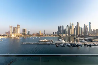 a view of a city with a harbor with boats at Sunrise Bay 2, Emaar Beachfront - Mint Stay in Dubai