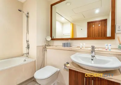 a bathroom with a sink and a toilet and a mirror at 2 Bed Room in Attessa Tower, Dubai Marina by Desert City Stays in Dubai