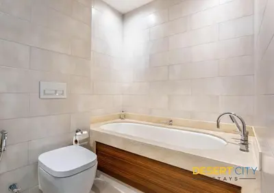 a bathroom with a bath tub and a toilet at 2 Bed Room in Attessa Tower, Dubai Marina by Desert City Stays in Dubai