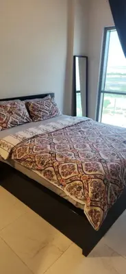 a bed with a colorful comforter on top of it at a chilled place in Dubai