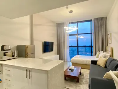 a kitchen and living room with a bed and a couch at O2R26- Elegant Studio in O2 Residential Tower in Dubai
