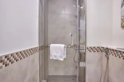 a shower with a glass door in a bathroom at Elegant 1BR in Vera Minutes from Dubai Mall in Dubai