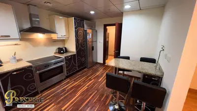 a kitchen with a stove and a counter top at Prestige holiday home Bed space in Dubai