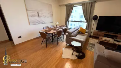 a living room with a couch and a table at Prestige holiday home Bed space in Dubai