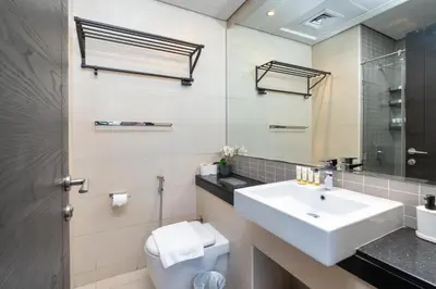 a bathroom with a sink and a mirror at Vacay Lettings - Silverene Marina Retreat - Waterfront Apartment Steps from Marina Mall in Dubai