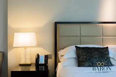 a bedroom with a bed and a lamp and a pillow at The Timeless in Dubai