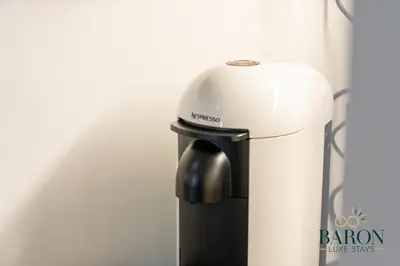 a black and white blender sitting next to a wall at The Timeless in Dubai