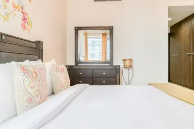 a bedroom with a large white bed and a window at Luxury 1BR Apartment Executive Towers Business Bay in Dubai
