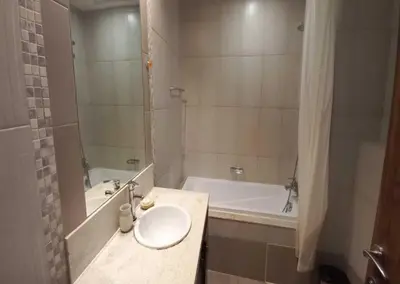 a bathroom with a sink and a tub and a toilet at Luxury 1BR Apartment Executive Towers Business Bay in Dubai