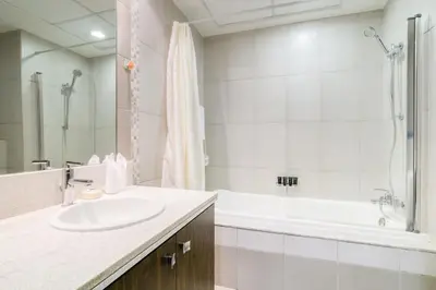 a bathroom with a sink and a tub and a shower at Luxury 1BR Apartment Executive Towers Business Bay in Dubai