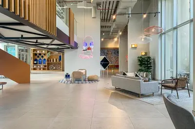 a lobby with a couch and chairs in a building at Frank Porter - Collective Tower 1 in Dubai