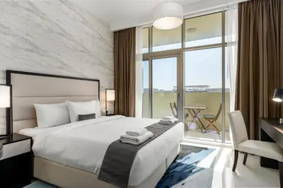 a bedroom with a large bed and a large window at Vacay lettings - Upgraded studio at Damac tower JVC in Dubai