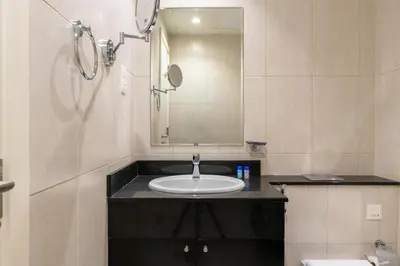 a bathroom with a sink and a mirror at Vacay lettings - Upgraded studio at Damac tower JVC in Dubai