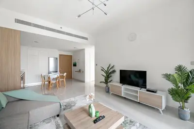 a living room with a couch and a flat screen tv at Free Beach Access! Beautiful Palm Jumeirah & Dubai Eye in Dubai