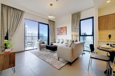 a living room with white furniture and large windows at Vacationer I Executive 1 Bedroom I Free Parking & Wi-Fi in Dubai