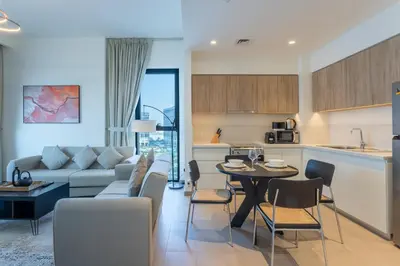 a living room and kitchen with a couch and a table at Vacationer I Executive 1 Bedroom I Free Parking & Wi-Fi in Dubai