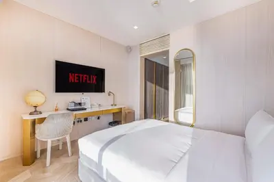 a hotel room with a white bed and a desk at FIVE Palm Jumeirah 2BR Luxury Penthouse, Private Pool, Full Marina Sea View in Dubai