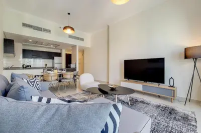 a living room with a couch and a flat screen tv at Bay Central, Central Tower - Tranquil Two Bedroom in Dubai