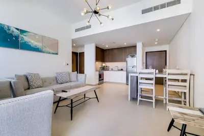 a living room with a couch and a table and a kitchen at 5242 Tower 2 - Light One Bedroom in Dubai