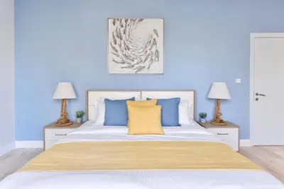 a bedroom with blue walls and a bed with blue pillows at Luxury JBR · Marina View · 5* Beach Resorts Access in Dubai