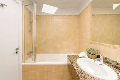 a bathroom with a tub and a sink and a shower at Luxury JBR · Marina View · 5* Beach Resorts Access in Dubai