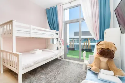 a bedroom with two bunk beds and a teddy bear at Perfect 2br for families in JVC in Dubai
