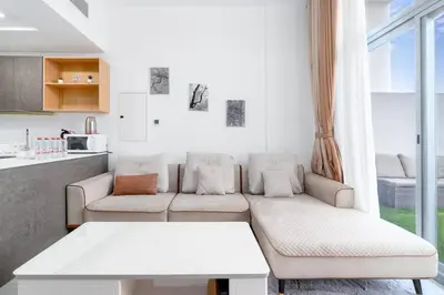 a living room with a couch and a table at Perfect 2br for families in JVC in Dubai