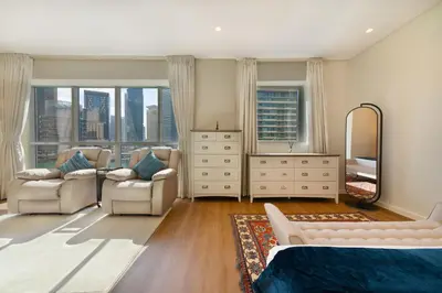 a bedroom with a bed and a dresser and a mirror at Maison Privee - Stunning 3-Floor Villa with Kids Room & Rooftop Terrace over Dubai Marina in Dubai