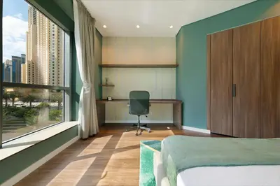 a bedroom with a bed and a desk and a window at Maison Privee - Stunning 3-Floor Villa with Kids Room & Rooftop Terrace over Dubai Marina in Dubai
