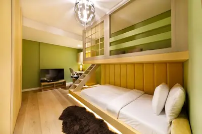 a room with a bunk bed and a tv at Maison Privee - Stunning 3-Floor Villa with Kids Room & Rooftop Terrace over Dubai Marina in Dubai