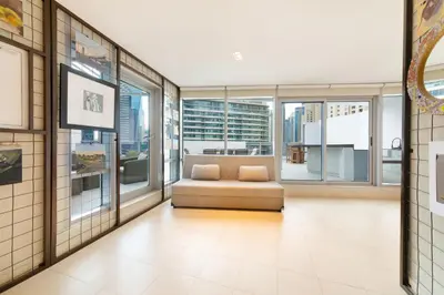 a living room with a couch and large windows at Maison Privee - Stunning 3-Floor Villa with Kids Room & Rooftop Terrace over Dubai Marina in Dubai