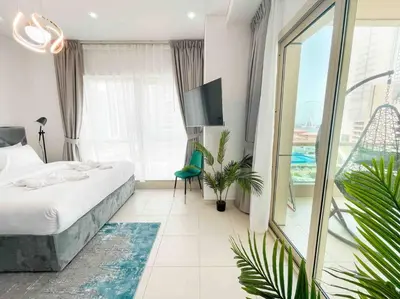 a hotel room with a bed and a large window at Royal Oceanic in JBR by HAPPY SEASON in Dubai