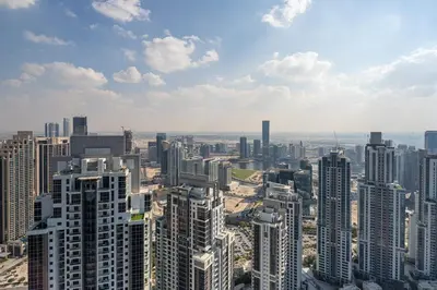 an aerial view of a city with tall buildings at Frank Porter - Paramount Midtown in Dubai