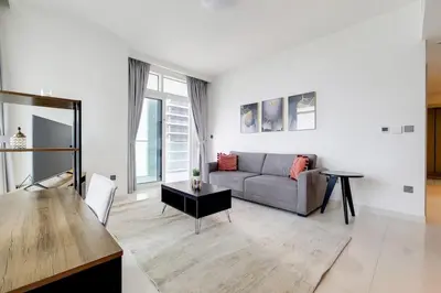 a living room with a couch and a table at Sunrise Bay 2 - Chic Two Bedroom in Dubai