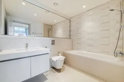 a bathroom with a sink and a tub and a toilet at Sunrise Bay 2 - Chic Two Bedroom in Dubai