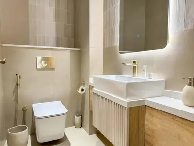 a bathroom with a white sink and a toilet at Upgraded 2BR apartment at the beach - Shoreline 1 in Dubai