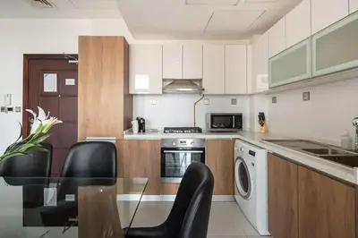 a kitchen with a table and chairs in a kitchen at Frank Porter - Starz by Danube in Dubai
