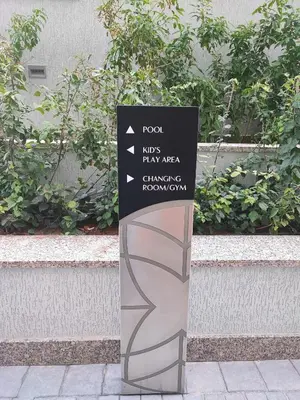 a sign on a sidewalk in front of a building at New 2 bedroom in Meydan - Green Area in Dubai